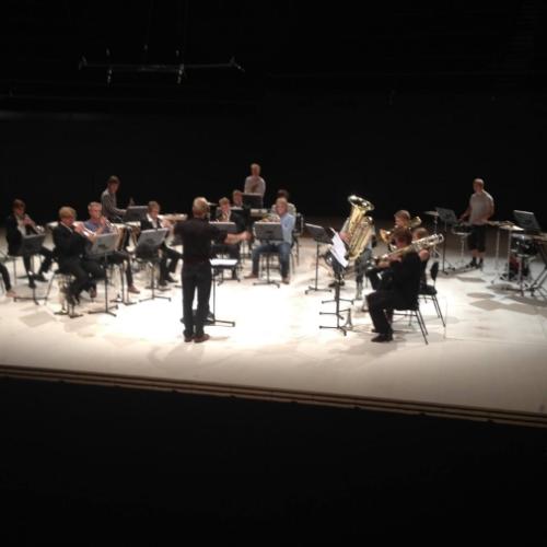 Brass orchestra is playing on a stage